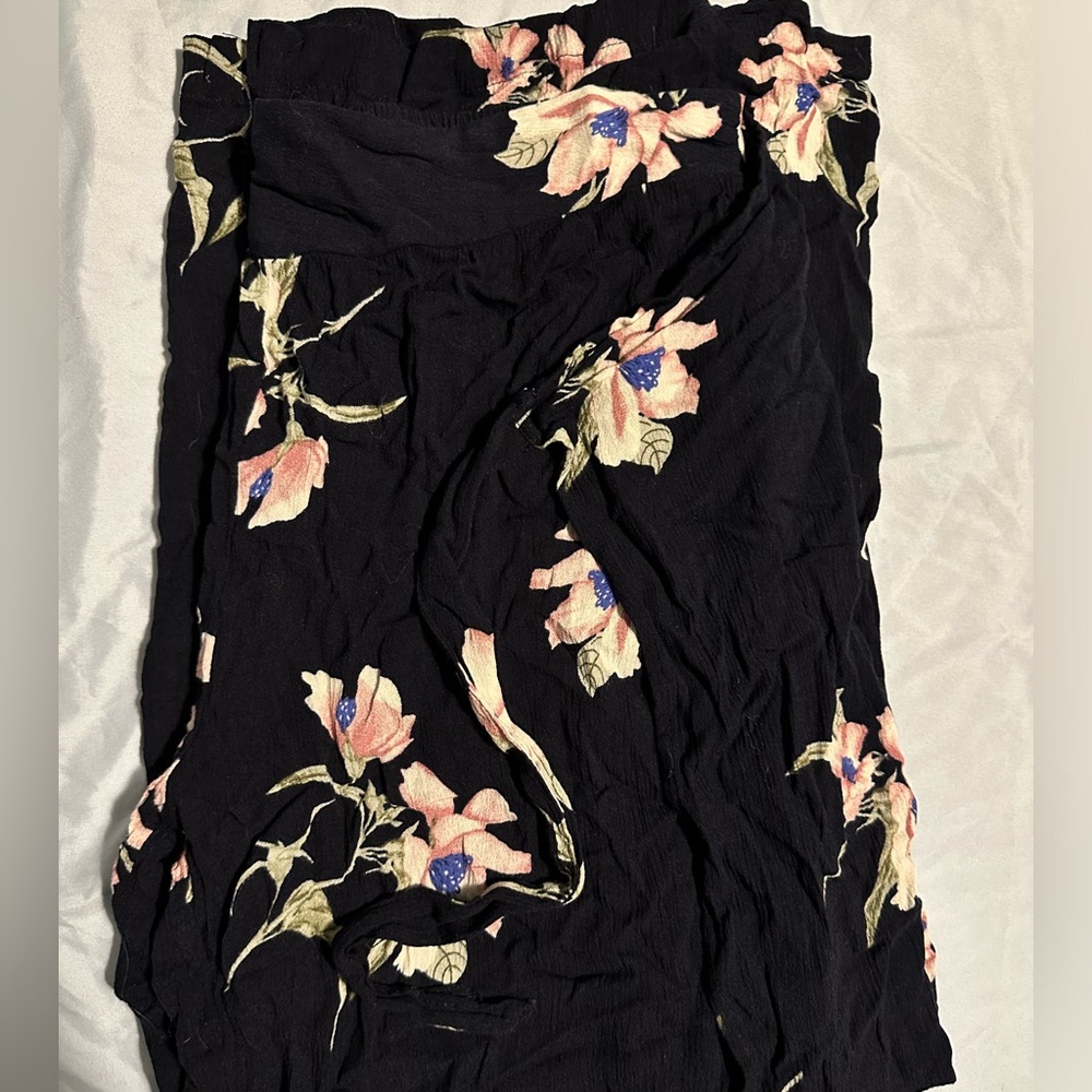 Black pants with white flowers on them.